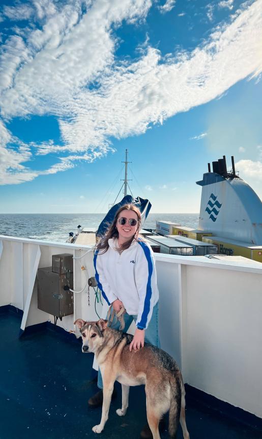 girl with dog on ship
